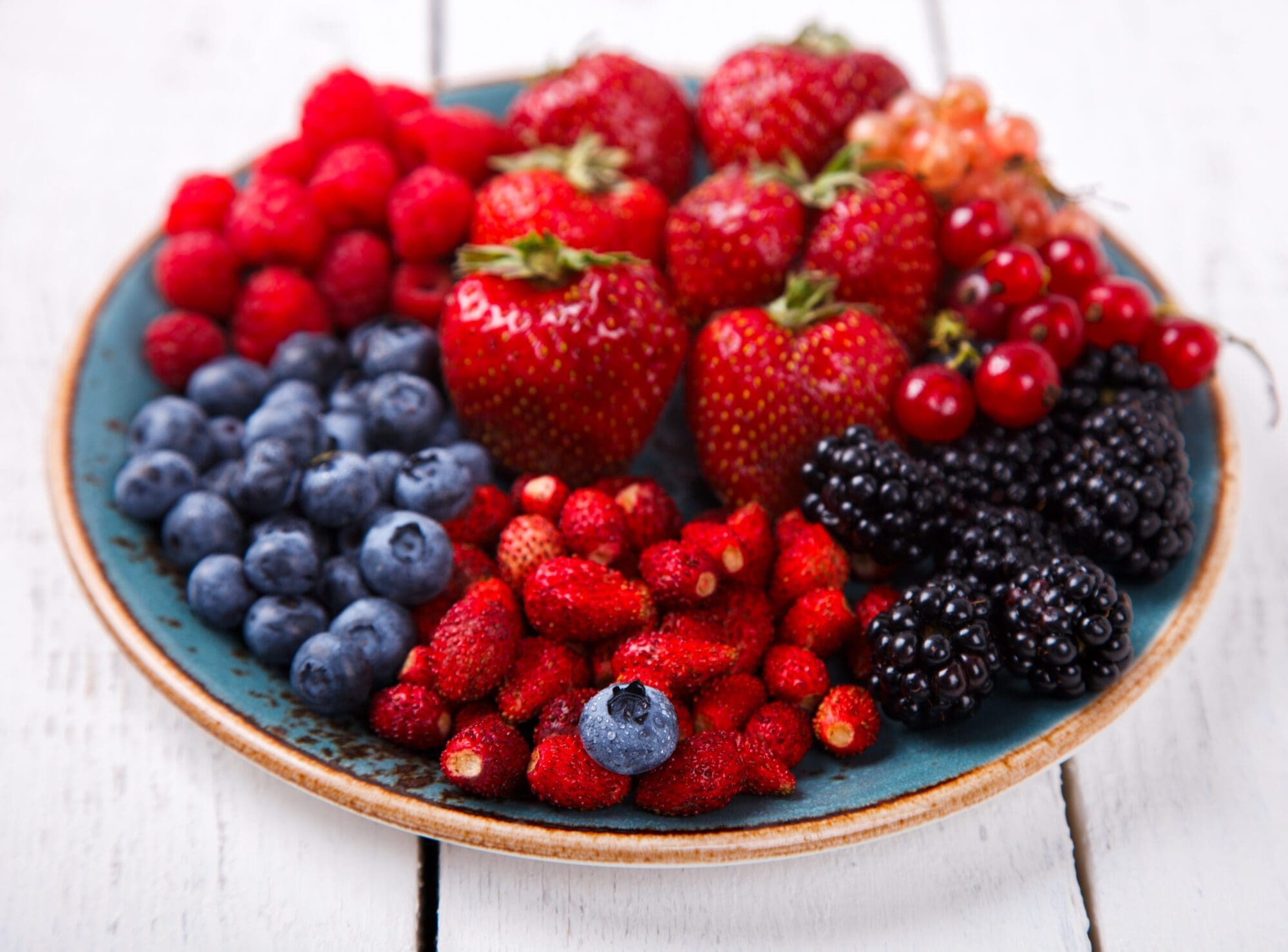 Various Fresh Summer Berries on a white Background.F Summer Berries